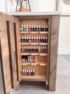 Custom built nail polish cabinet inside bathroom vanity.
