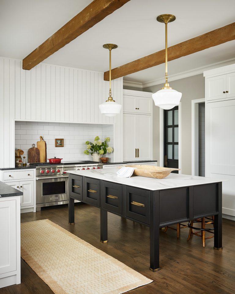Custom Cabinetry Trends white shiplap kitchen with wood beams. Black marble counter tops. Designer Alessia Zanchi Loffredo